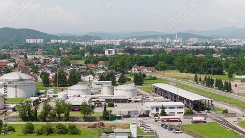 This aerial view shows a petroleum storage terminal with large fuel tanks and industrial structures.