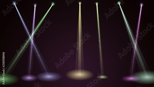Stage spotlights shining vertical and diagonal beams of colored light onto a dark floor with spotlight background illumination lighting performance entertainment atmosphere abstract backdrop