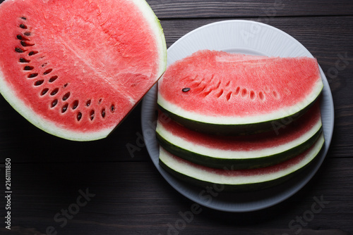 Pieces of ripe watermelon on wooden table