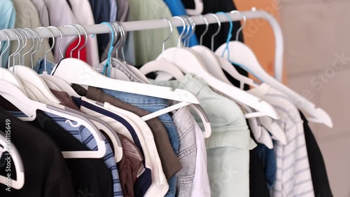 Organized Closet with Clothes on White Hangers - Wardrobe Storage and Clothing Organization.