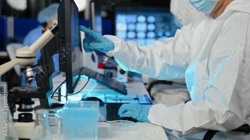 Female Scientist Looking Under Microscope in medicine chemical biology medical science experiment technology biotechnology analysis
