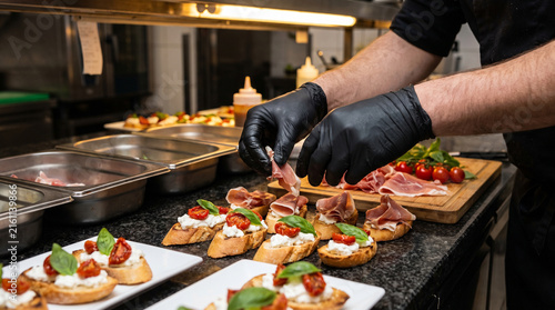 Fotografía Chef hands assembling gourmet prosciutto burrata bruschetta crostini platter