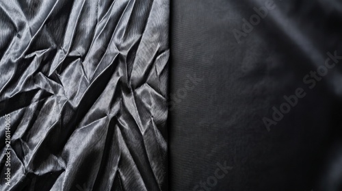 Black Silk Fabric Texture with Wrinkled and Smooth Contrast Surface.
