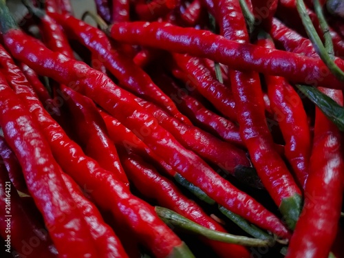 Obraz na płótnie Close up view of a heap of fresh red curly chili peppers