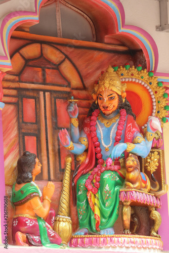 Fotografie Stone wall relief carving of Lord Narasimha sitting on a throne and blessing the devoted boy Prahlada