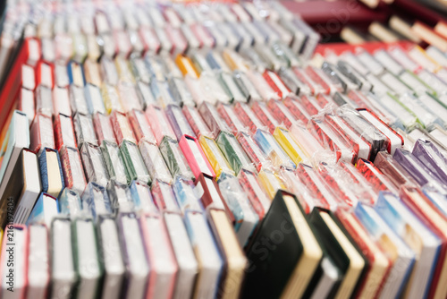 Cuadro en lienzo Vibrant assortment of colorful notebooks in a stationery store
