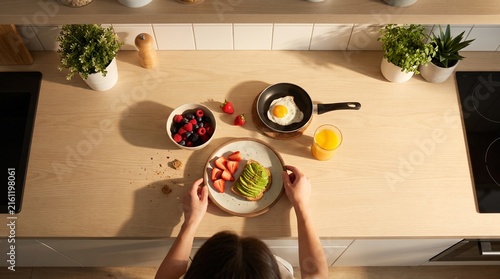 Top Down Morning Breakfast Preparation with Toast Fruit Eggs and Juice