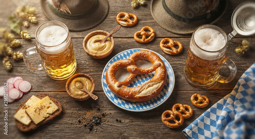traditional oktoberfest pretzels beer cheese bread mustard wooden table