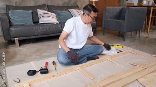 Furniture man assembly wood living room tool glove ruler floor home repair project sofa chair rug wooden frame