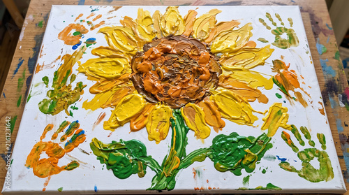 Textured sunflower painting created with thick paint and handprints.
