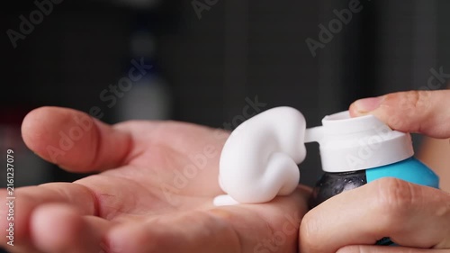 Person Dispenses White Shaving Foam Into Open Palm, Close Up View Supports Personal Grooming and Hygiene
