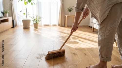 Close Up Person Sweeping a Wooden Floor in a Modern Home