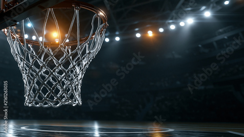 Basketball hoop net in dark stadium illuminated by bright arena lights for professional competitive sports event promotion.