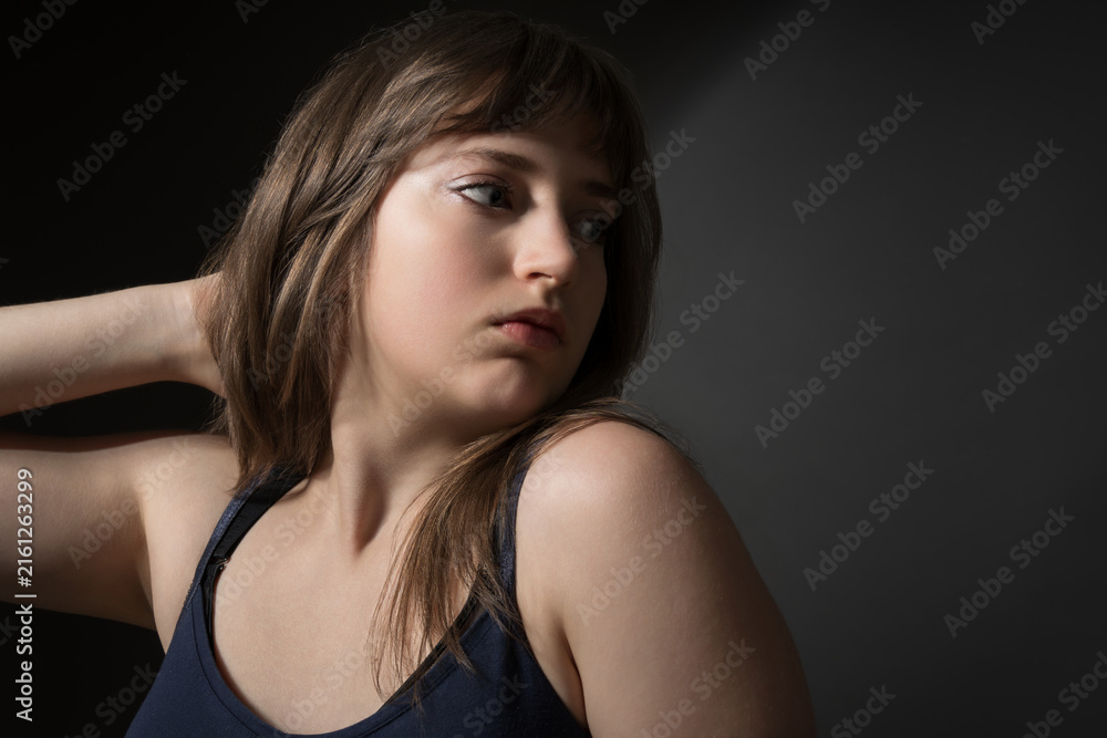 Fototapeta premium Beautiful Teenage Girl Posing for Beauty Portrait on Dark Background