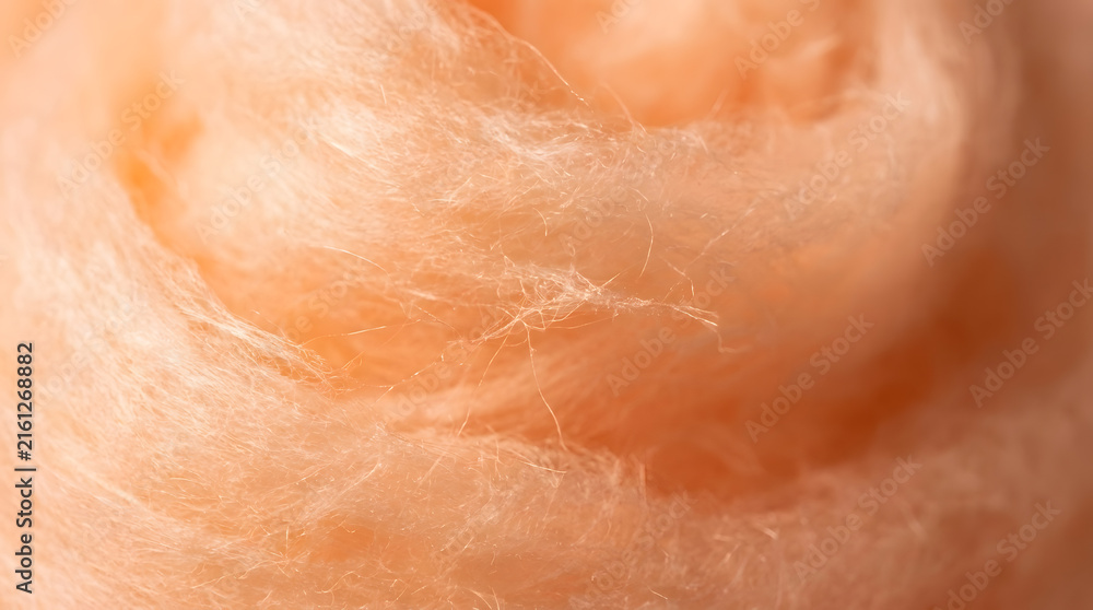 Fototapeta premium Soft orange cotton candy texture | Macro photography of peach wool fibers | Fluffy pastel orange abstract background | Delicate peach fibrous texture for design