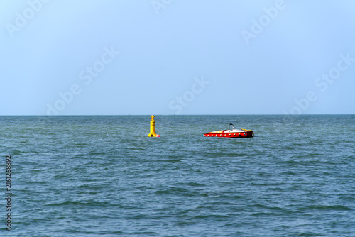 Fotografie English Channel with yellow buoy and horizon at French city of Le Havre on a summer day