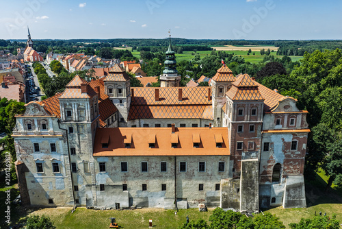 Aerial view of the Ducal Castle in Niemodlin, Poland with market square, old town, colorful buildings and streets in the historic city center on a sunny day. Castle and square in Niemodlin, Poland