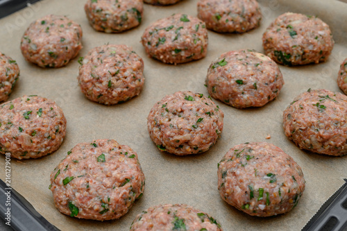 Fresh homemade minced meat cutlets with fresh herbs,