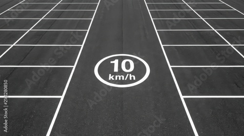 Cleanly Marked Empty Parking Lot With Speed Limit Sign