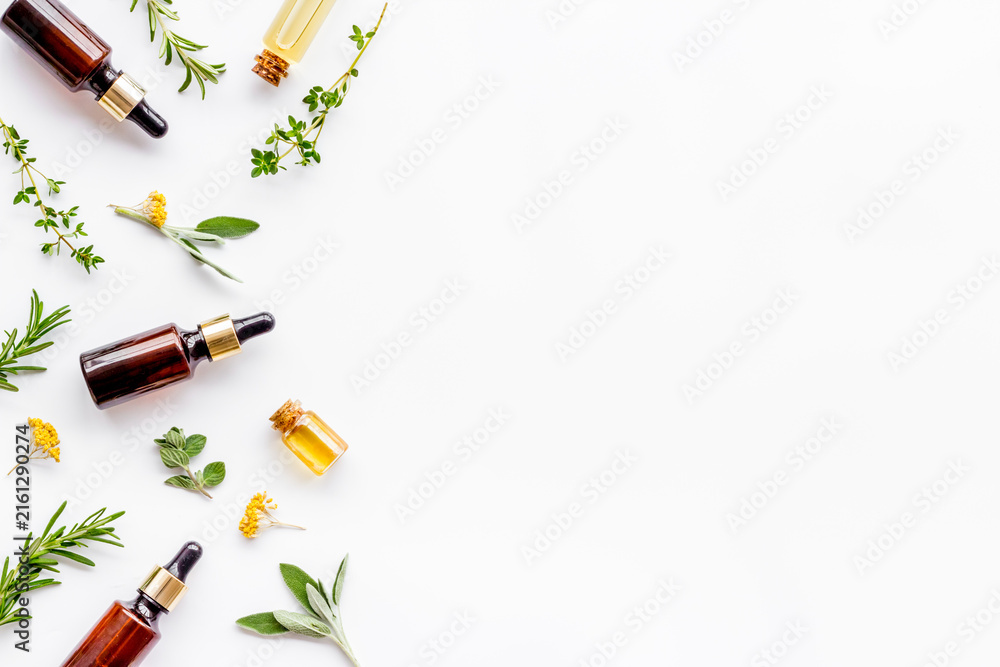 Fototapeta premium Essential oils and fresh herbs on white background top view pattern frame copy spacee