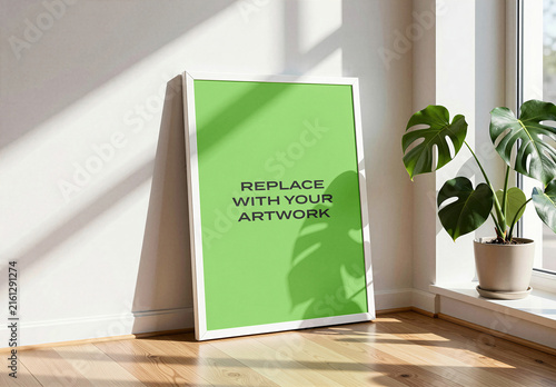 Vertical framed poster mockup displayed on a white interior wall, realistic art presentation with natural window light, wooden floor and potted monstera plant, Template