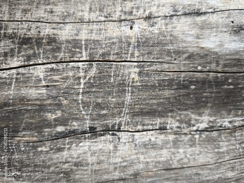 Weathered grey wooden plank surface with deep natural cracks and rustic texture
