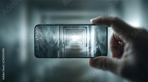 Hand holding smartphone captures surreal tunnel scene, blending reality and digital imagery. tunnel appears to extend infinitely, creating mesmerizing visual effect