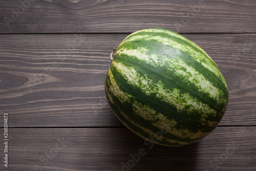 Striped watermelon on wooden table