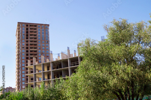 Unfinished buildings. Shrubs around the buildings.