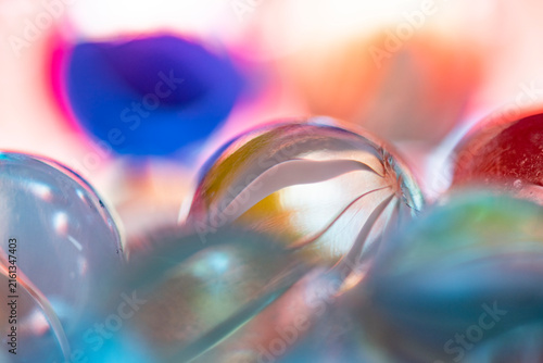 Glass marbles creating abstract colorful light reflections