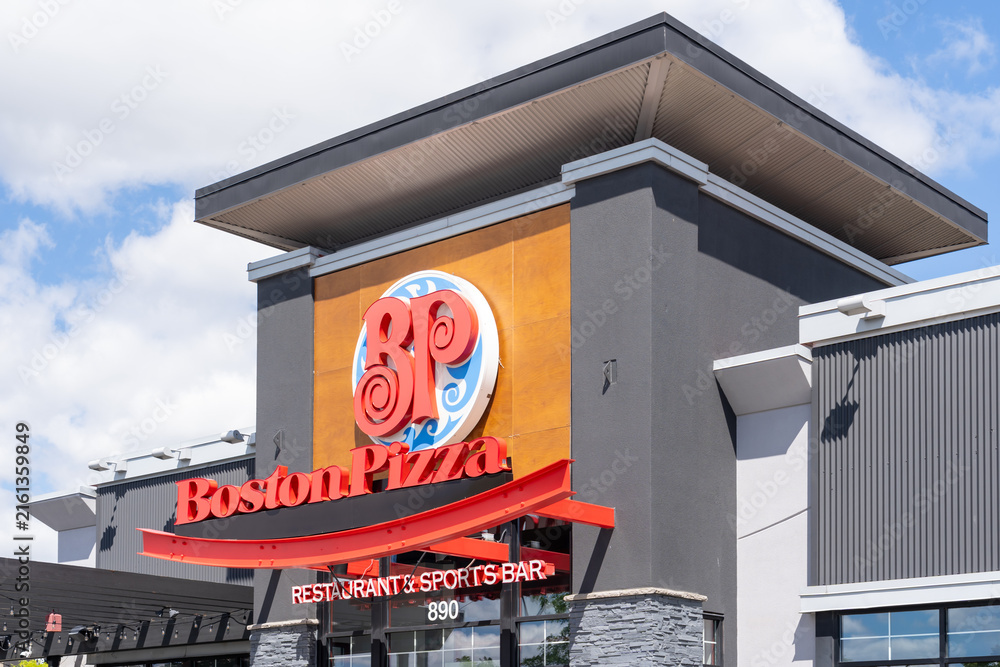 Fototapeta premium Toronto, ON, Canada - August 17, 2026: Closeup exterior storefront signage of a Boston Pizza restaurant and sports bar on the building in Toronto, ON, Canada. 