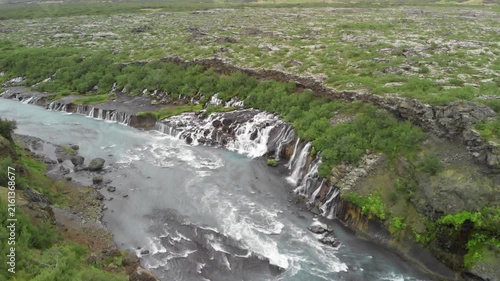 Hraunfossar Waterfalls, Iceland. Aerial view from drone on a summer day. Slow motion