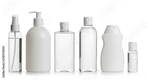 Set of six empty white and transparent cosmetic plastic bottles for skincare lotions creams sanitizers and toiletries isolated on white background