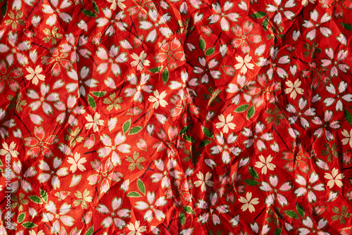 Red background blooming Crumpled Origami Paper with Traditional Japanese Pattern