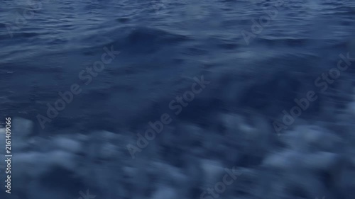 Fast moving sailboat wake on deep blue sea