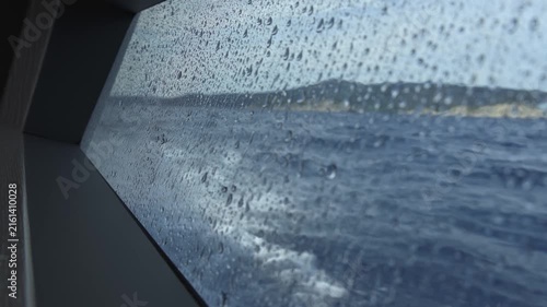 Sailing boat porthole viewing splashing sea waves