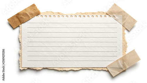 Blank vintage lined paper note fixed with adhesive tape isolated