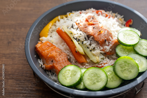 Close-up of a healthy salmon fillet served with rice and steamed vegetables
