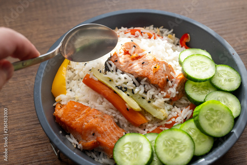 Close-up of a healthy salmon fillet served with rice and steamed vegetables