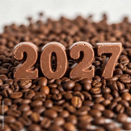 Chocolate Numbers 2027 on Coffee Beans Background.