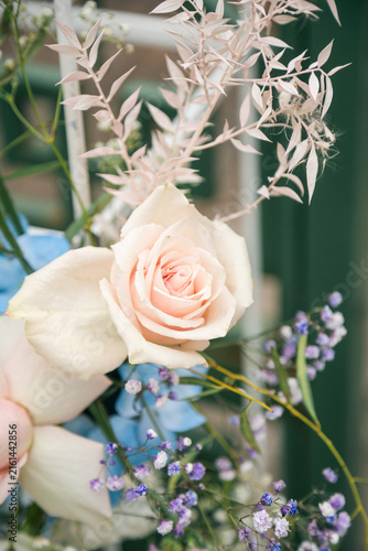Beautiful Floral Decoration at an Outdoor Wedding Ceremony, Elegant Wedding Flowers and Arch Setup in Natural Sunlight