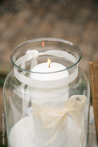 Burning Decorative Candle in Soft Natural Light, Cozy Interior Still Life with Warm Flame and Minimalist Decor