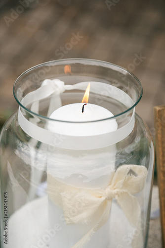 Burning Decorative Candle in Soft Natural Light, Cozy Interior Still Life with Warm Flame and Minimalist Decor