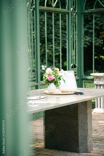Wedding Altar Table with Floral Arrangement set in a Park, Outdoor Ceremony Setup in Soft Natural Daylight