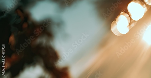 Soft-focus abstract with warm light beams and muted tones