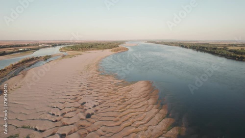 Aerial view of abstract sand patterns and flowing Danube River during low river levels	and drought
