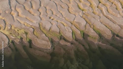 Aerial view of abstract sand patterns and flowing Danube River during low river levels	and drought
