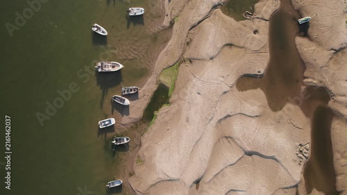 Aerial view of stranded boats on newly exposed Danube riverbank during severe low water