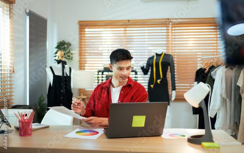 Young man running online fashion design business from home