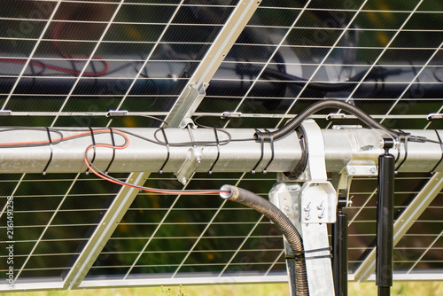 Fotografie Close up of single axis solar tracking mechanism featuring support bracket, hydr